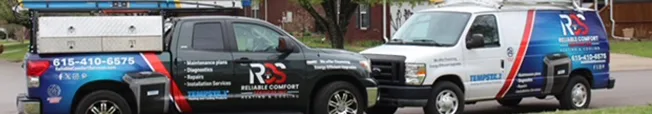 Reliable Comfort Services branded service trucks parked outside a Murfreesboro home