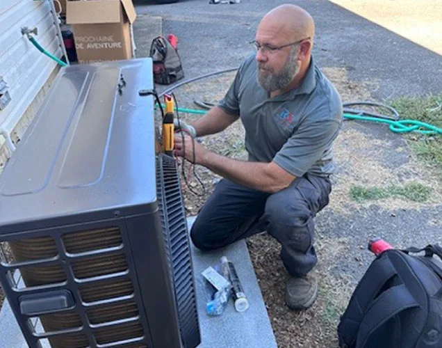 A Reliable Comfort Services technician servicing a ductless mini-split system at a Murfreesboro home