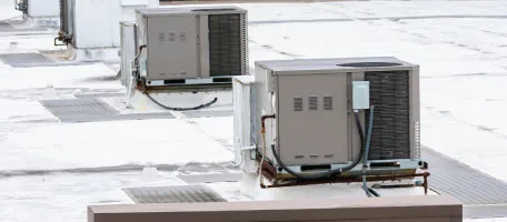 A pair of rooftop HVAC units stand on a flat commercial roof, quietly keeping a Murfreesboro business comfortable through every season.