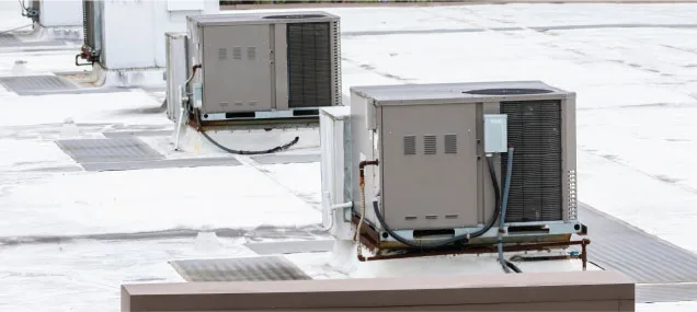 Commercial rooftop HVAC units installed on a business building, providing reliable climate control for the facility.