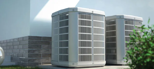 Two sleek outdoor units sit alongside a home, ready to keep the family cool through the summer and warm through the winter.