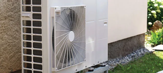 A sleek wall-mounted mini-split indoor unit provides efficient heating and cooling to a modern living room without the need for ductwork.